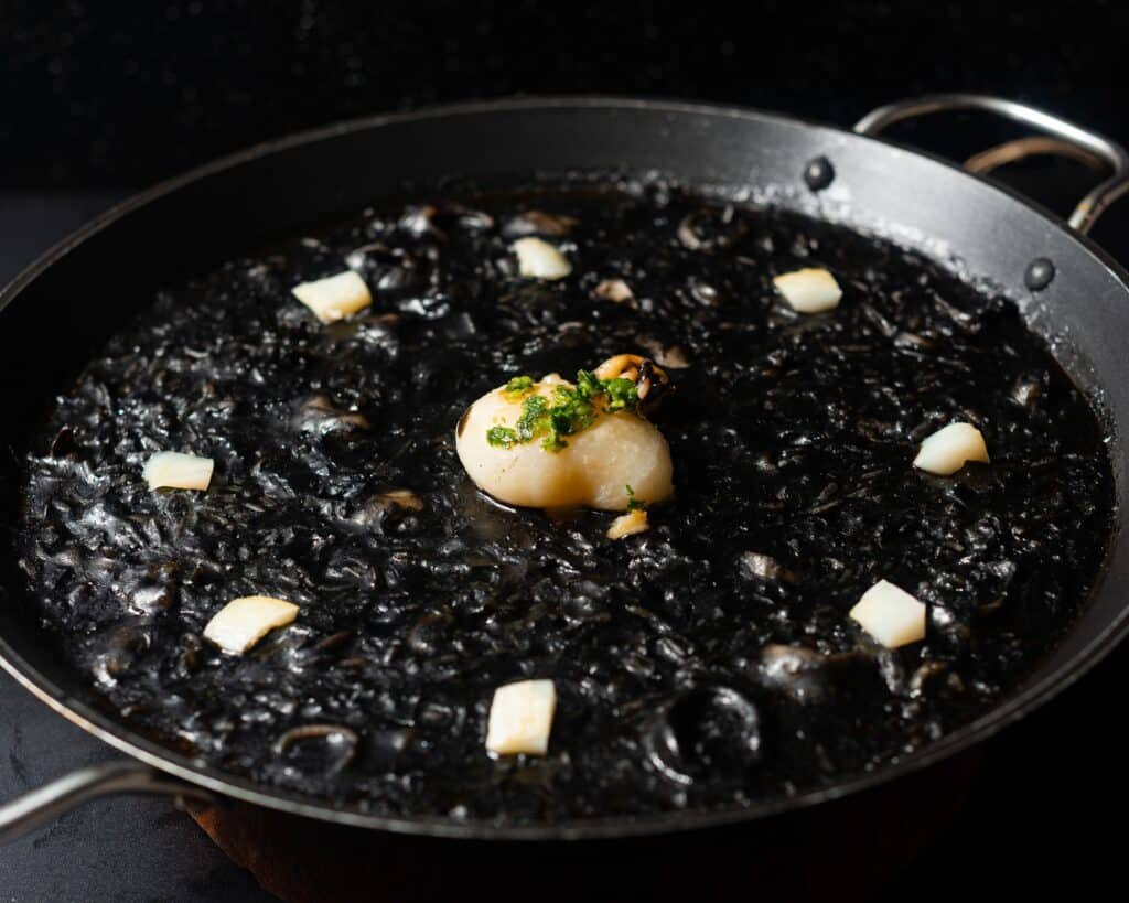Closeup of a freshly made delicious Arroz negro dish in a pan